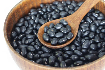 Black bean in bowl on white background.