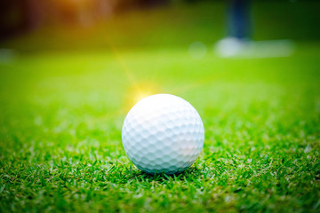 Golf ball on green in beautiful golf course at sunset background. Golf ball on green in golf course at Thailand