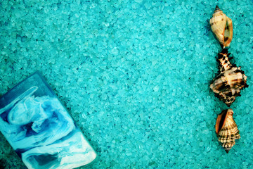 handmade soap and seashells on the background of sea salt