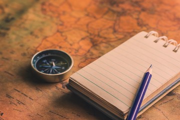 Notepad for note with pencil, compass on paper map for travel adventure discovery image