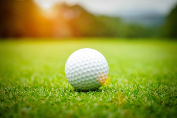 Golf ball on green in beautiful golf course at sunset background. Golf ball on green in golf course at Thailand