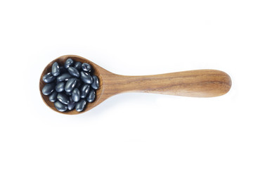 Black bean in spoon on white background.