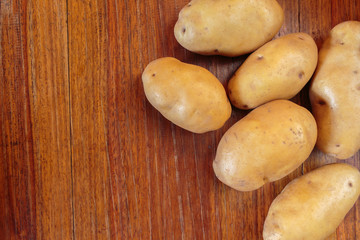 pile potato on wooden table.