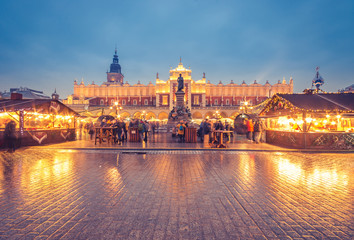 Fototapeta na wymiar Krakow, Poland, Main Square, Cloth Hall, Mickiewicz statue and Christmas fairs