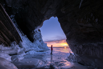 Tourist meets the dawn of the grotto on Lake Baikal