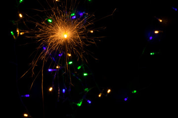 sparkler with blur new year's light close up