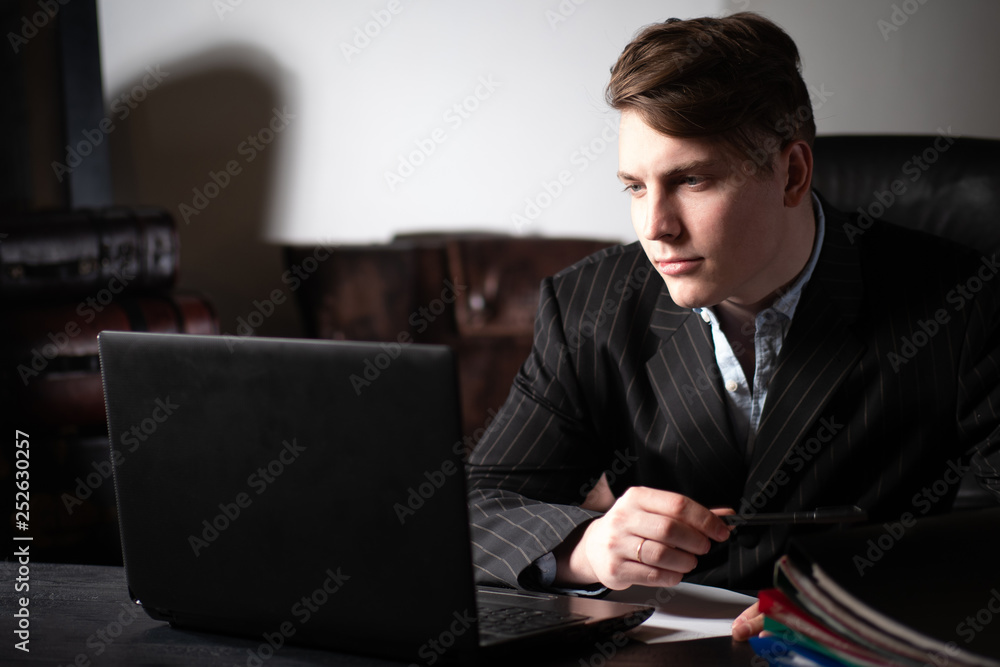 Poster work at the computer. a man analyzes the data. performing work at the computer. remote work. a man i