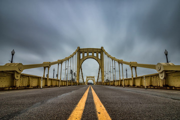 Yellow suspension bridge in Pittsburgh Pennsylvania.  - Powered by Adobe