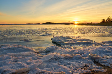 Frozen beach and icy sea on a sunset in Ruissalo, Finland.  