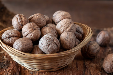 Whole walnuts on a rustic old wooden table