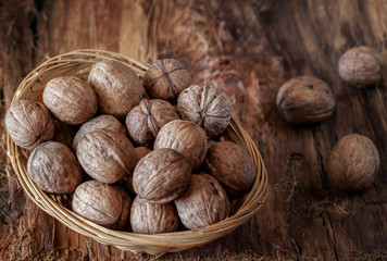 Whole walnuts on a rustic old wooden table