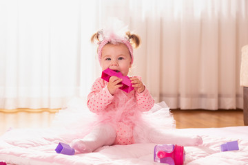 Fototapeta premium Baby girl playing with toy blocks