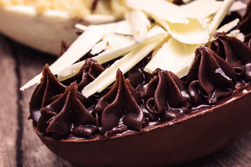 Easter eggs filled with dark chocolate and white chocolate. Brazilian Easter egg to be eaten with spoon, tasty dessert.