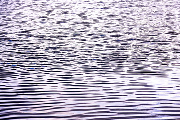 Obraz premium Abstract background of wave on the surface, river surface with sun light reflected on water skin, Smooth liquid surface and shadow of clouds sky on river, Ripple of wave flow on river