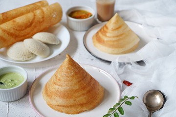 South Indian breakfast cone shaped dosa Idli sambar and chtney background