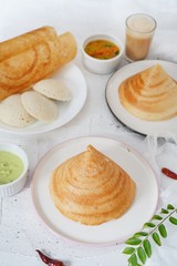 South Indian breakfast cone shaped dosa Idli sambar and chtney background