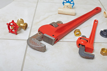 Fototapeta premium Plumbing wrench on the bathroom ceramic floor.