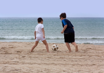 Children playing with a ball on the beach