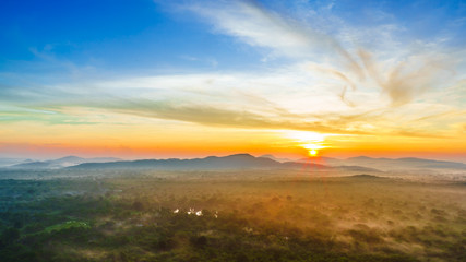 Fototapeta na wymiar View on sunrise over the foggy jungle from Pidurangala Rock in Sri lanka