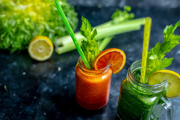 vegetable and fruit smoothies in various colors on a dark, warm background