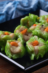 close up of steamed pork dumplings on plate