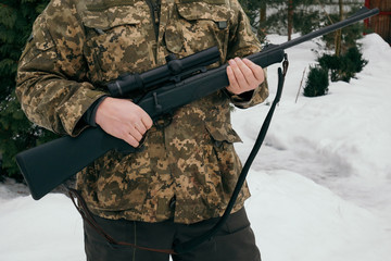 Soldier in military uniform with snipers carbine