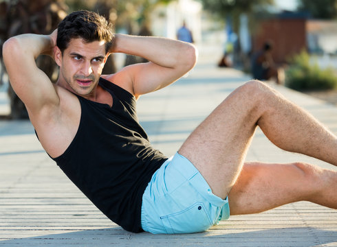 Man doing abs crunches outdoor