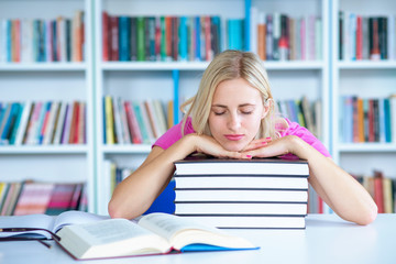 female student study in library using laptop and searching for informations on internet