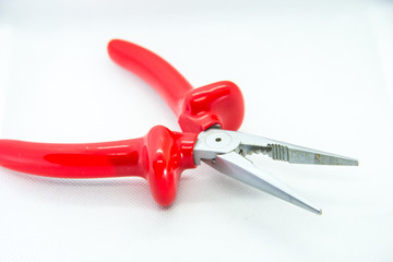 red pliers on white background