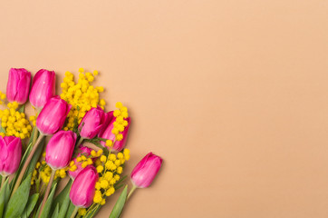 Bright Spring beige background with spring flowers. Free space. Copy space.Top view. Tulips and...