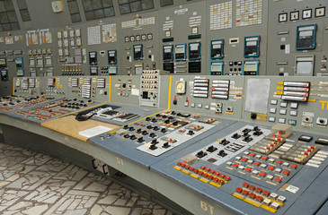 Operator sits in front of the  main control board in a control operations room of the reactor of...