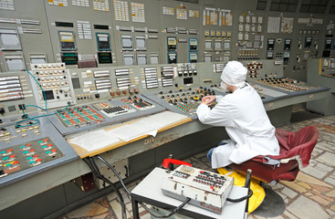 Operator sits in front of the main control board in a control operations room of the reactor of the Chernobyl Nuclear Power Plant
