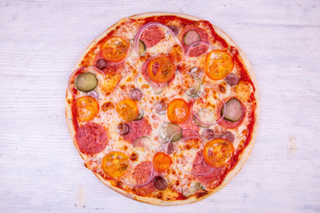 Pizza Bavarian with gherkins, salami and tomatoes