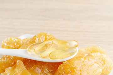 Natural solid collagen and capsules in container on the table