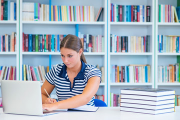 Female student studying at college library