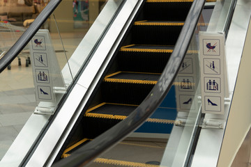Mechanical escalators for people with warning signs