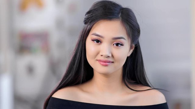 Close-up portrait young Asian beautiful girl wearing natural makeup and fresh skin looking at camera