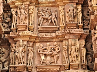 Sex poses from the kamasutra, erotic close - up of intricate carved scenes on the walls of Hindu temples in the Western group of Khajuraho, India