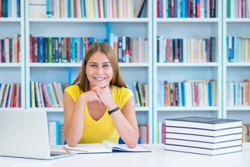 Female student studying at college library