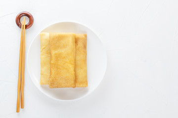 Chinese tortillas - bings in a plate on a white background.View from above. Copy space