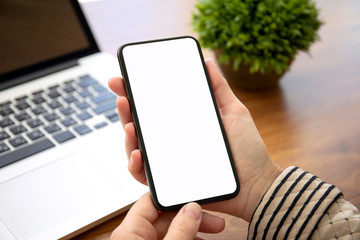 female hands holding phone with isolated screen in the office