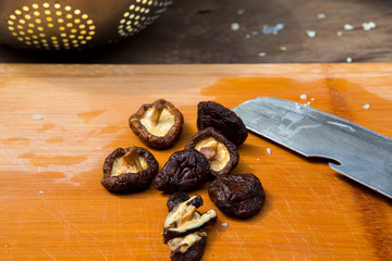 Religious, devout believers help prepare the ceremonial offerings, cut the mushrooms