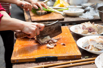 Chinese traditional religious beliefs, devout believers help prepare sacrifices for ceremonies, lick chicken