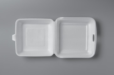 Open white styrofoam lunch box for takeaway food on grey background for print design and mock up