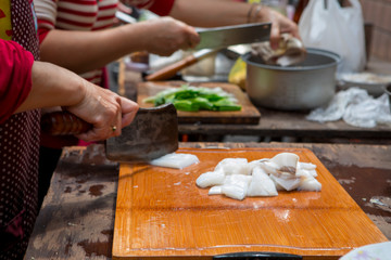 Traditional religious beliefs, devout believers prepare sacrifices, cut squid, squid