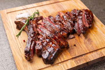Food and horse meat concept - Roast meat on cutting board with cumin