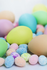 Colorful Assorted sizes Pastel Happy Easter Eggs sunny background with copy space