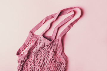 ecological way of life, green lifestyle, eco friendly string bag isolated on pink background