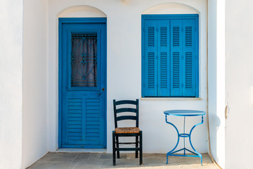 Fototapeta na wymiar Greek house with blue windows and doors in beautiful Sifnos island. Cycladic architecture. Greece
