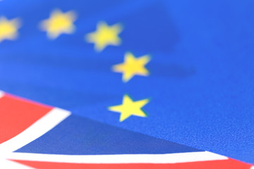 Background of EU and UK waving flags, part of Union Jack visible with copy space. Brexit and cooperation concept